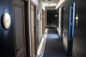 a corridor of a hallway with a clock on a wall at Letoh Letoh Gran Vía in Madrid