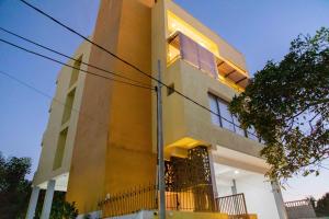 a yellow building with a window on the side of it at ARON'S Lavinia RUBY in Mount Lavinia