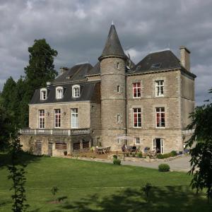 a large stone building with a tower at Hotel Le Domaine De La Ferriere in Buléon