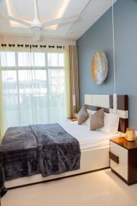 a bedroom with a large bed and a window at ARON'S Lavinia TOPAZ in Mount Lavinia