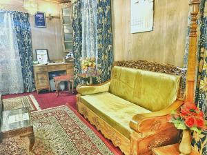 a living room with a couch and a table at Lake Victoria Houseboats in Srinagar +24 photos