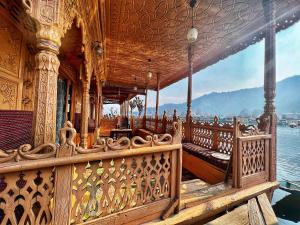 a large wooden deck with a view of the water at Lake Victoria Houseboats in Srinagar