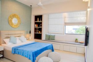 a bedroom with a bed and a window and a mirror at ARON'S Lavinia EMERALD in Mount Lavinia
