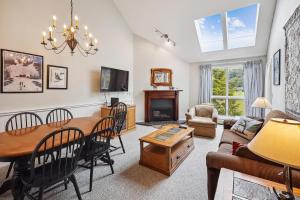 a living room with a table and a dining room at Pico F305 in Killington