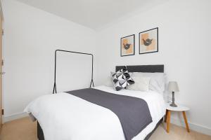 a bedroom with a white bed with a black and white blanket at Royal Derby Hospital Mickleover Town House in Derby