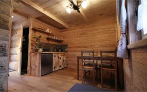 a kitchen with a table and chairs in a cabin at Tutok in Zakopane