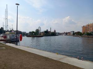 a view of a river with a ferris wheel in the distance at Old Town Nadmotławie - Sauna & Gym I 10min deptak in Gdańsk
