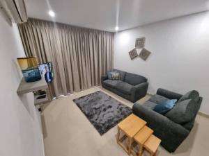 a living room with a couch and a table at Luxurious 1 Bedroom Apartment Available in Accra