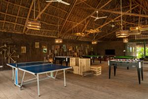 a large room with ping pong tables in it at Fun Beach Hotel in Jambiani