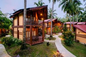 an exterior view of a resort with palm trees at Silver Sand Beach Resort Neil in Neil Island