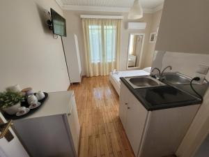 a small kitchen with a sink and a refrigerator at Villa Petros in Nydri