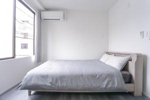 Postel nebo postele na pokoji v ubytování ZAITO Tokyo Skytree-Yokokawa II Studio 天空树旁舒适型民宿-宅东横II号店