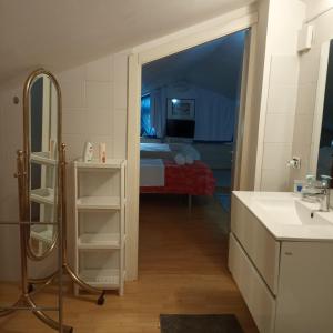 a bathroom with a sink and a room with a bed at Giardini e Mare in Quartu SantʼElena