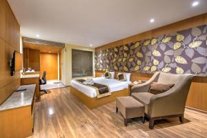 a hotel room with a bed and a chair at Silver Sand Sentinel in Port Blair