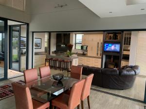 a living room with a glass table and a couch at House Vos in Hermanus