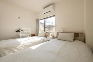 Postel nebo postele na pokoji v ubytování ZAITO Tokyo Skytree-Yokokawa II Studio 天空树旁舒适型民宿-宅东横II号店