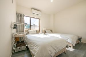Postel nebo postele na pokoji v ubytování ZAITO Tokyo Skytree-Yokokawa II Studio 天空树旁舒适型民宿-宅东横II号店