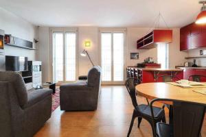 a kitchen and living room with a table and chairs at UCA14 Luxury large apartment with private terrace in Citylife in Milan