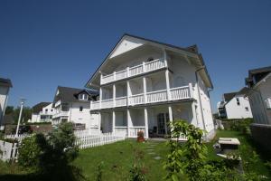 a large white house with a lawn in front of it at Villa Gesine App 01 - Strandkorb in Nienhagen