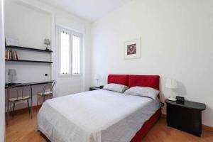 a bedroom with a large bed and a desk at SV18C Charming modern flat S Ambrogio in Milan