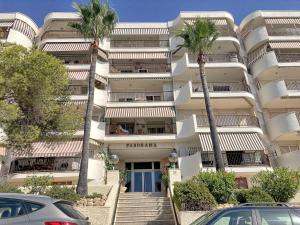 a large apartment building with palm trees in front of it at 069 - Panorama 001 - comfortHOLIDAYS in Santa Pola