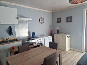 a kitchen with a table and a kitchen with a sink and a stove at Les deux écureuils in Vresse-sur-Semois +4 photos