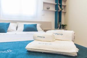 a room with two beds with towels on the floor at GIOSAHOUSE in Uggiano la Chiesa +80 photos