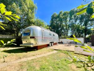 an old airstream trailer parked in a yard at Airstream at Hardham West Sussex Sleeps 4 in Pulborough