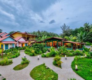 an exterior view of a resort with a garden at Silver Sand Village Resort in Havelock Island