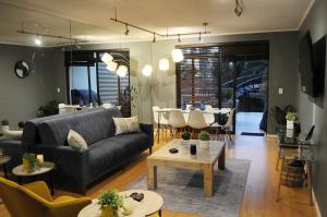 a living room with a couch and a table at Luxury 2 bedroom apartment in Cape Town in Cape Town