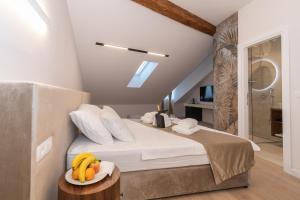 a bedroom with a bed with bananas on a table at Trecento Boutique Rooms in Split