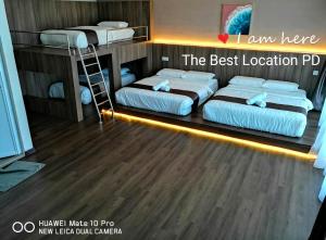 two bunk beds in a room with a ladder at THE BEST LOCATION in Port Dickson
