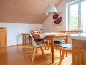 a kitchen with a table and chairs and a dining room at Ferienwohnung Denn in Langenargen