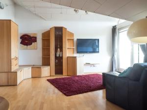 a living room with a couch and a tv at Ferienwohnung Denn in Langenargen