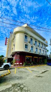 a building with a parking lot in front of it at Domsowir Hotel and Restaurant in Borongan
