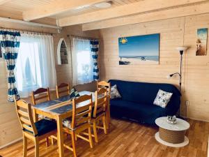 a living room with a table and a blue couch at Złoty Brzeg Wicie in Wicie