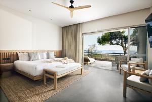 a bedroom with a bed and a view of the ocean at Samphire Rottnest in Rottnest Island