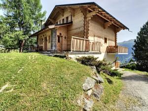 a log house on a hill with a yard at Gavroche Combles in Verbier