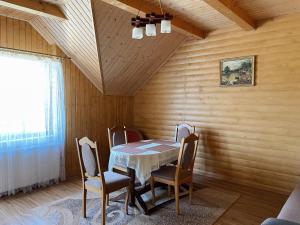 a dining room with a table and chairs at Сонячний Лаз in Polyana