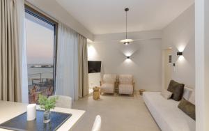 a living room with a view of the ocean at KALES SEA VIEW SUITES in Ierápetra