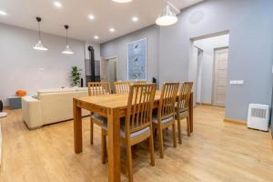 a dining room with a wooden table and chairs at Apartment Windau in Ventspils