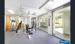 een fitnessruimte met loopbanden en machines in een kamer bij 2 Bed 2 Bath Apartment in Braddon, Canberra - Pool, Gym and Free Parking in Canberra
