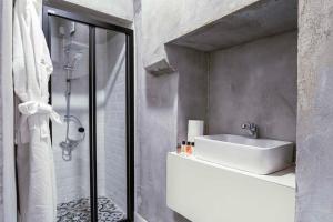 a white bathroom with a sink and a shower at Classy Furnished Studio in The Heart of Karaköy ( Karakoy 1 ) in Istanbul