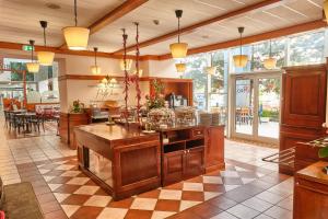 a large kitchen with a large island in a restaurant at MyContinental Bucuresti Gara de Nord in Bucharest