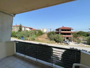 a balcony with a view of a building at Hidden Gem Apartment in Neoi Epivates