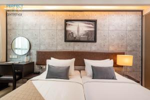 八打靈再也的住宿－Centrestage Petaling Jaya by Perfect Host，一间卧室配有一张大床、一张桌子和一面镜子