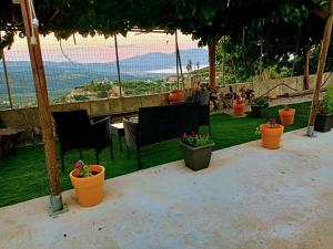 un grupo de sillas y macetas en un patio en Amazing View, en Kissamos