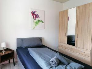 a bedroom with a bed and a dresser at Ferienwohnung Körner in Saarbrücken