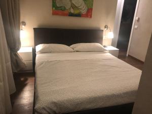 a bed in a room with a white bedspread at Linate Residence in Segrate