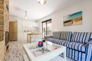 a living room with a couch and a table at VacationClub - Plażowa 7 Apartament 2 in Gąski
